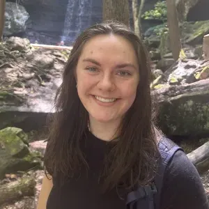 索菲亚·伊士曼，26岁 standing in front of a waterfall